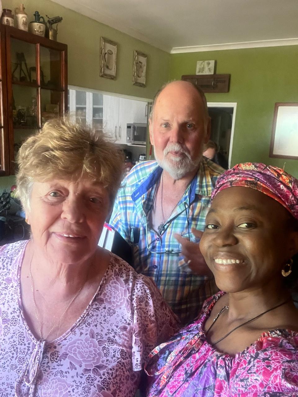 Grace Damilola taking a selfie with an older sister and brother in the kitchen
