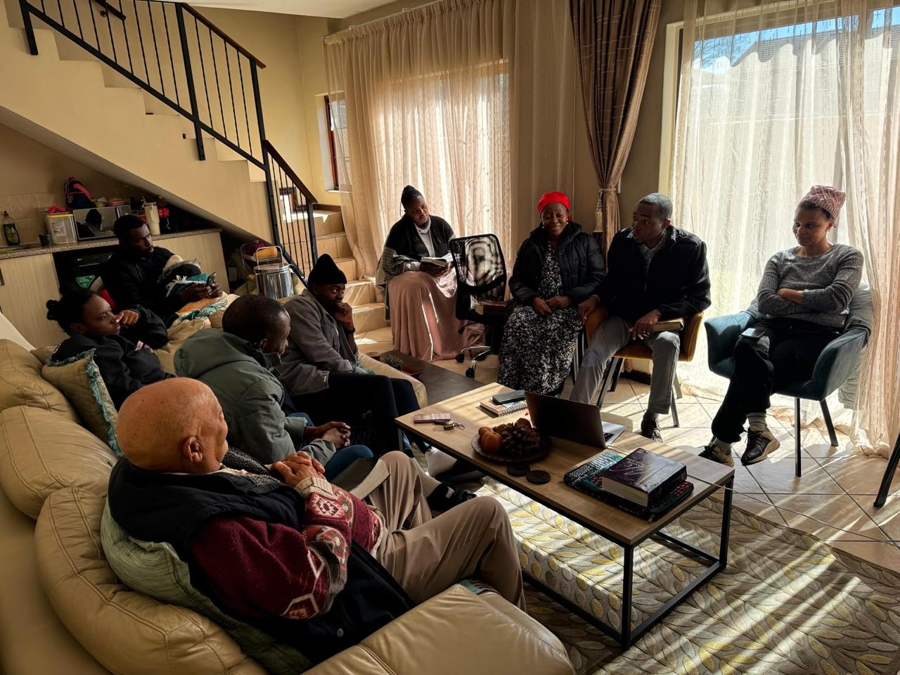 The gathering by the staircase listening to a Bible study at home