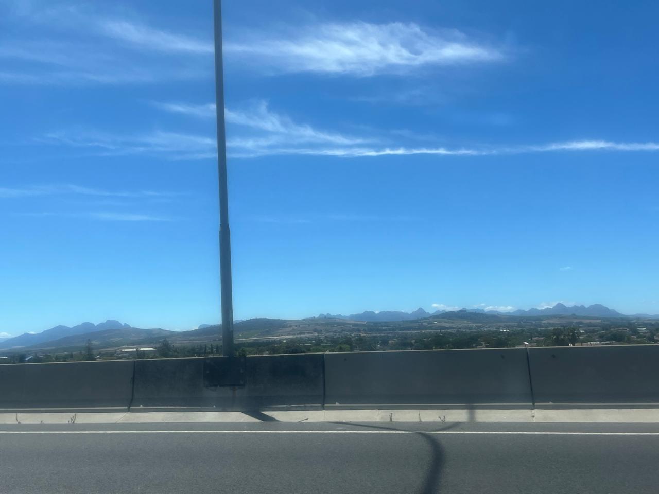 South African mountains on the horizon under a blue sky, seen from the highway