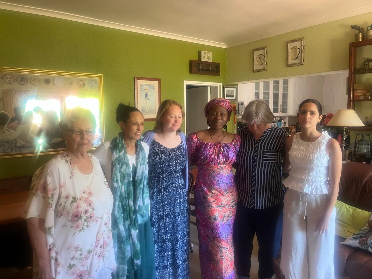 Sisters standing together in the lounge during a fellowship gathering